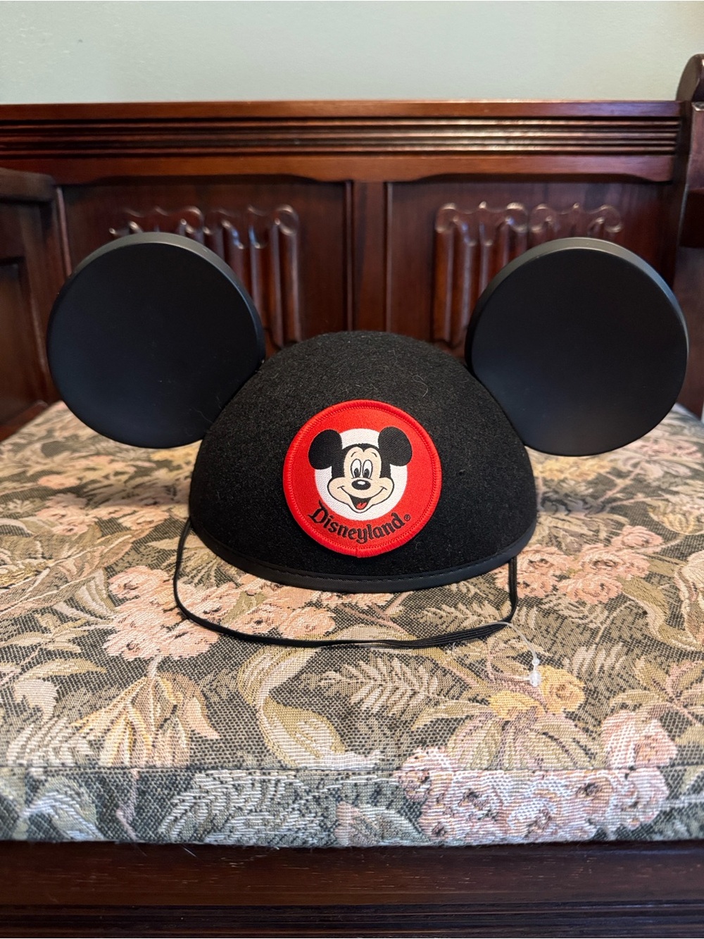 Disney black Mickey Mouse ears hat with red patch.